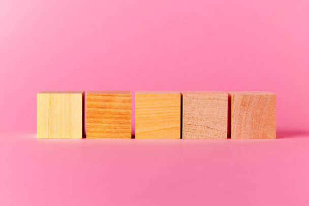 Toy wooden cubes with copy space against pink background - Foto, imagen