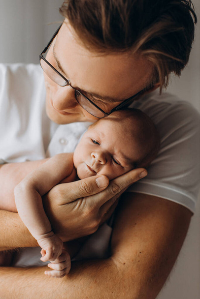Lovely father with adorable newborn baby girl, caring dad hold in arms beautiful little daughter, enjoy tender parenting moments, smiling, fatherhood concept - Φωτογραφία, εικόνα