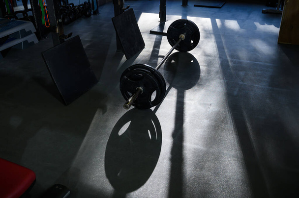 Barbell on the floor in the gym - Foto, imagen
