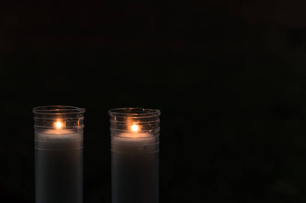 two simple burning candles with black background - Fotoğraf, Görsel