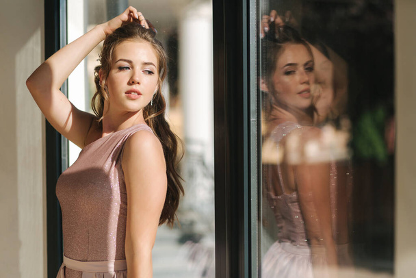 Elegáns fiatal nő áll a nagy ablak a luxus étterem - Fotó, kép