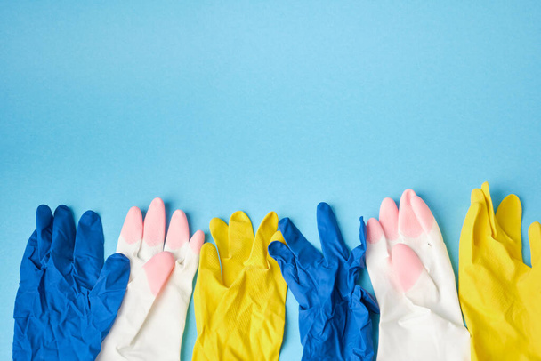 colorful of rubber gloves on blue background copy space - Foto, Imagem