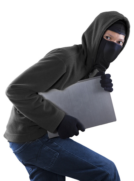 Thief stealing a laptop computer - Photo, image