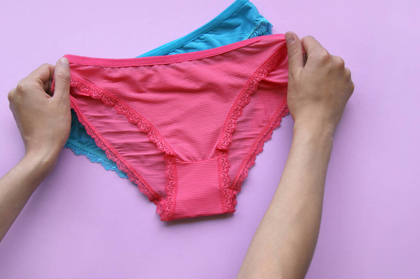 Set of women's panties on a pink background. Pink and blue underwear. - Photo, Image
