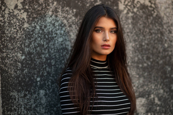 Young girl with straight brown hair, dressed in modern clothes, makeup. - Photo, Image