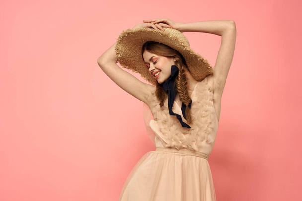 Fashionable woman in dress and hat with black ribbon on pink background cropped view of model emotions fun - Φωτογραφία, εικόνα