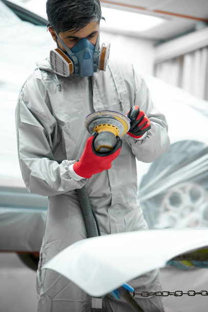 auto mechanic is concentrated on polishing of cars - Photo, image