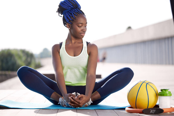 beautiful sporty woman do exercises on mat outdoors - Фото, изображение