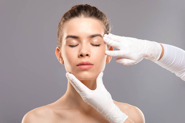 Attractive young woman getting treatment at beauty clinic - Photo, Image