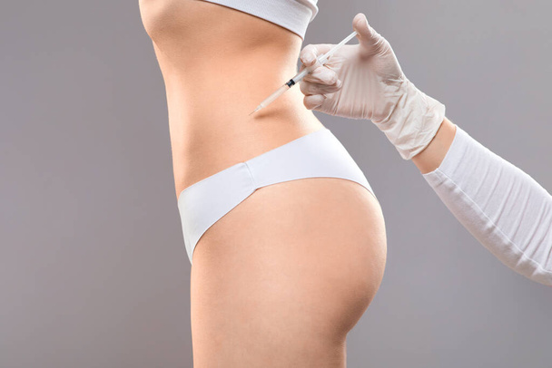 Slim woman having lipolysis treatment at beauty salon - Фото, зображення