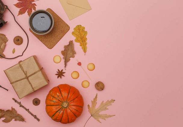Autumn flat lay on a soft pink background with a Cup of coffee, gift box and dry leaves. Top view with space for text - Φωτογραφία, εικόνα