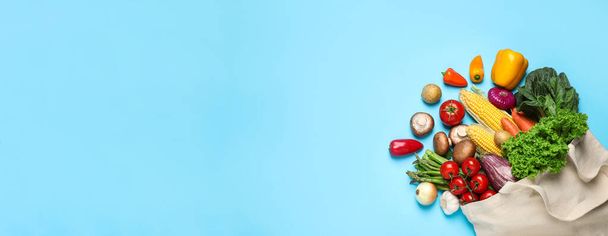 Many fresh different vegetables on light blue background, top view with space for text. Banner design  - Фото, изображение