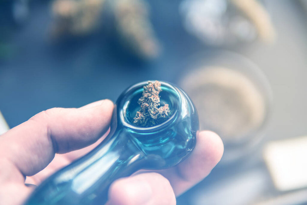 Cannabis legalisation. Marijuana smoking pipe CBD and THC on bud - Photo, Image