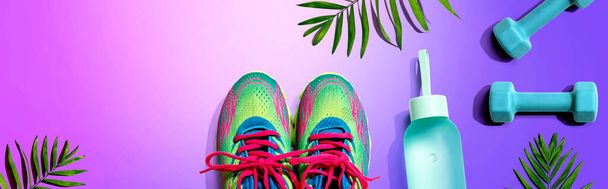 Fitness shoes and dumbbells with tropical plants - Photo, Image