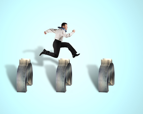 businessman jumping over euro obstacles  - Photo, Image