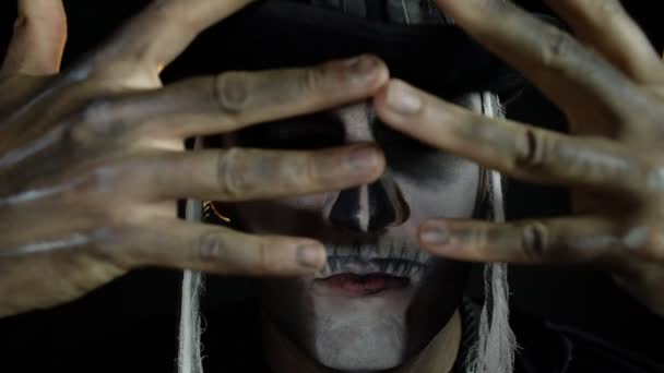 Man in skeleton Halloween cosplay costume. Guy in creepy skull makeup looking wide open eyes - Footage, Video