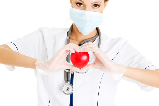Young nurse with heart in her hand - Foto, Imagem