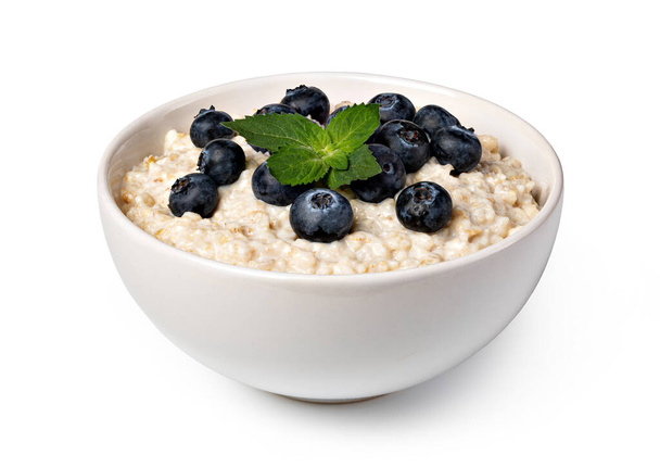 prepared oatmeal with blueberries isolated on white background - Photo, Image