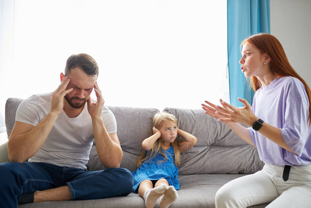 child girl is suffering from quarrels between parents in the family at home - Φωτογραφία, εικόνα