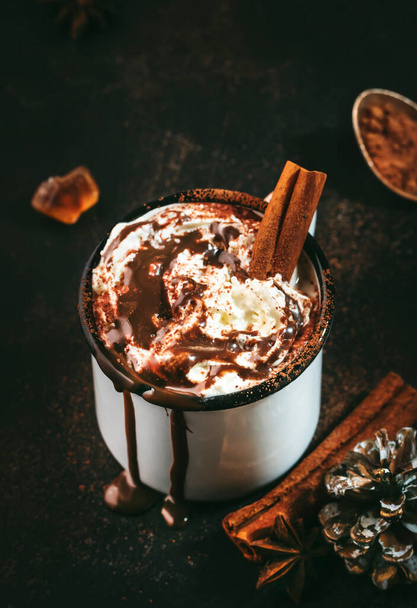 Hot chocolate with whipped cream and cocoa powder in metal mugs. Winter and autumn time. Christmas warm drink. Copy space - Zdjęcie, obraz