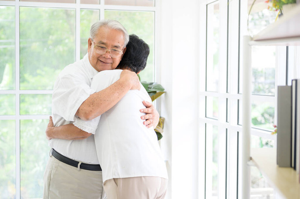  A senior elderly couple are hugging in home, together , family concept . - 写真・画像