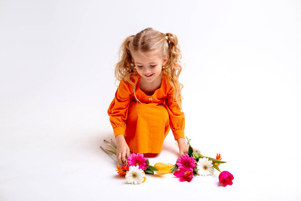 cute little girl with flowers in studio - Zdjęcie, obraz