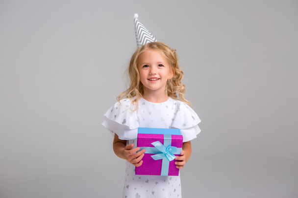 little girl in white dress with gift - Photo, Image