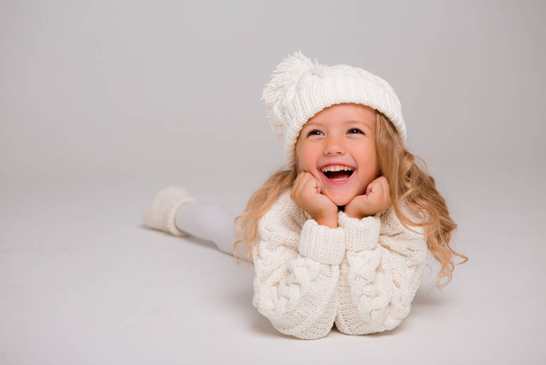 klein meisje in witte trui  - Foto, afbeelding
