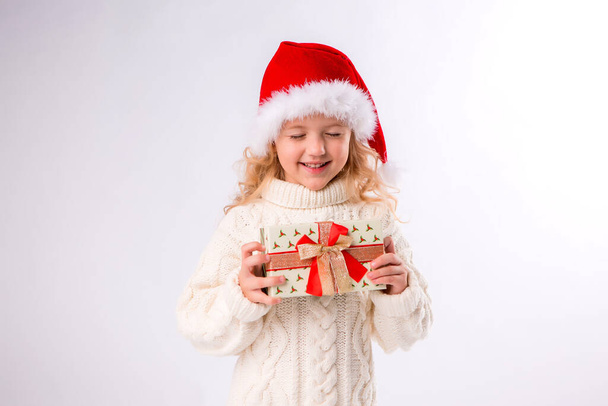 little girl in white sweater with gift, Christmas concept  - Φωτογραφία, εικόνα