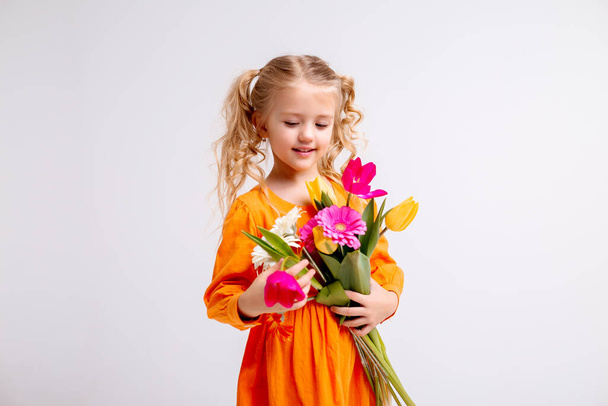 cute little girl with flowers in studio - Foto, immagini