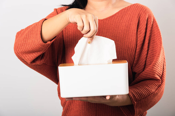 Young woman flu she using hand taking pulling white facial tissue out of from a white box for clean handkerchief, studio shot isolated on white background, Healthcare medicine concept - Photo, image