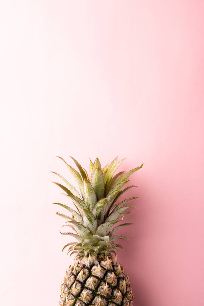 Close up above top view of ripe pineapple fruit on pink pastel background, Summer Tropical concept - Photo, Image