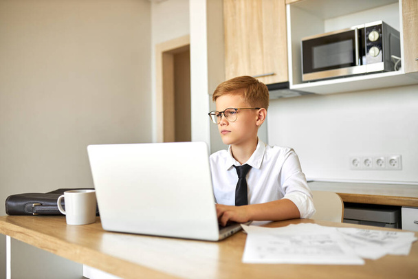 little caucasian boy work on laptop at home - Foto, Imagen