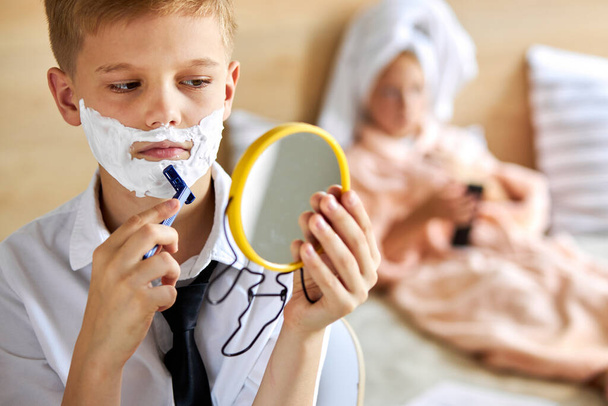 close-up portrait of child boy shaving beard - Foto, Imagem