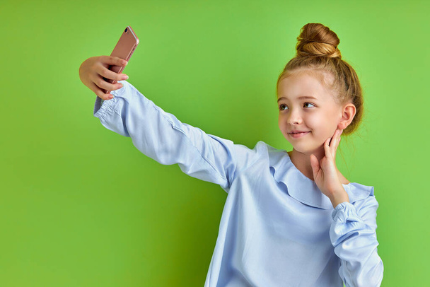 sweet positive child girl take selfie on mobile phone - Photo, Image