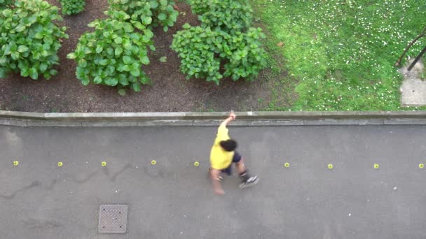 Europa, Italia, Milano - aprile 2020: boy rollerblade e skate tra i ninepins nel giardino di casa durante l'epidemia di coronavirus n-cov19 - attività e flash mob italiano - Filmati, video