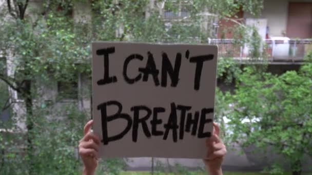 America, USA - white latin girl holding sign "I can't breathe" protest and manifest. Concept of racism and social violence  - Footage, Video