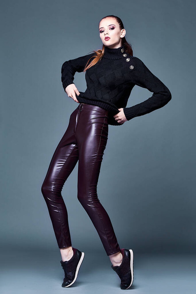 Beautiful sexy pretty woman perfect body shape face makeup wear black wool cashmere sweater and skinny lather pants sport shoes accessory casual clothes for party walk brunette hair fashion style. - Foto, immagini