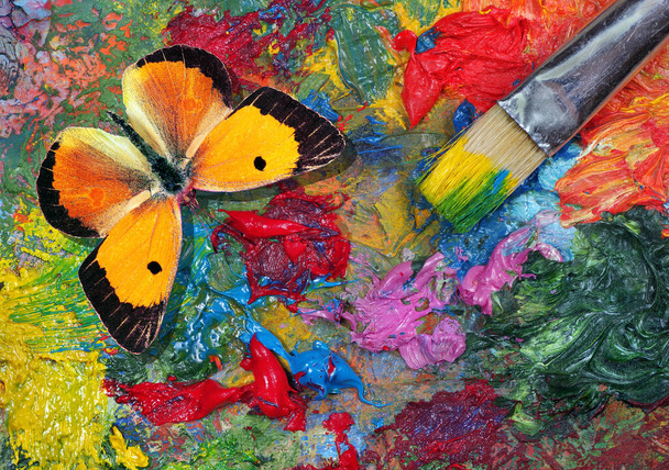 colorful orange butterfly on a artist's palette. artist's palette and brush texture background. top vew - Foto, Bild