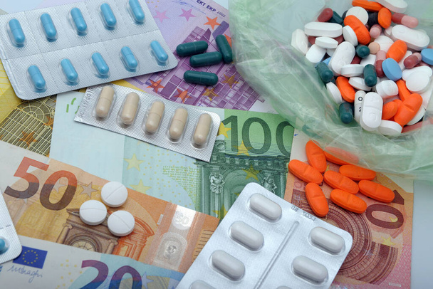Capsules pill in blister packaging and euro money - Pharmaceutical industry concept. Pharmacy drugstore. Antibiotic drug resistance - cost of sanity - Photo, Image