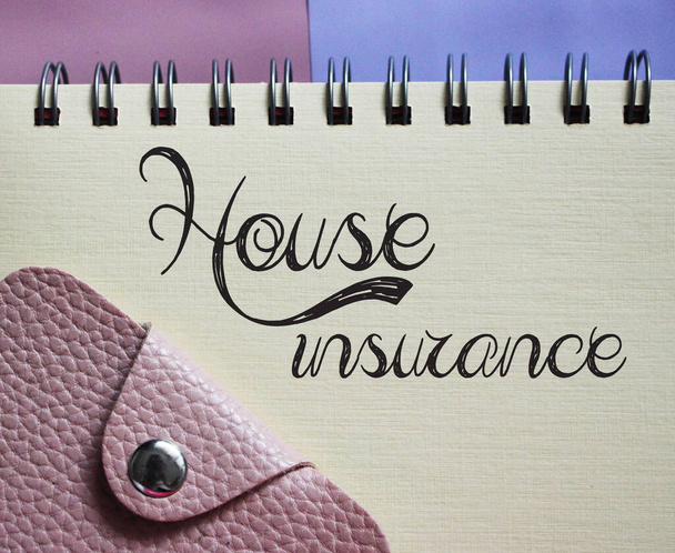 Copybook with the phrase house insurance written on it with wallet. Real estate loan business concept. - Photo, Image