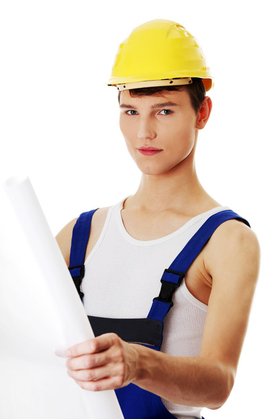 Young builder man holding plans - Foto, afbeelding