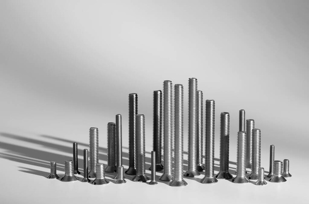 Nuts and bolts on gray background - Photo, Image