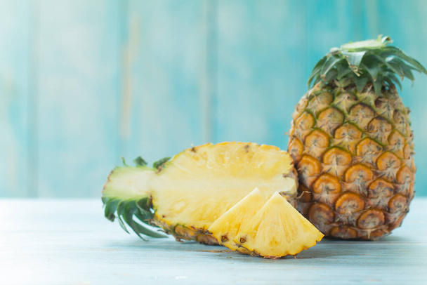 Ripe pineapples summer tropical fruits on pastel turquoise background. Summer fruit concept. - Фото, изображение