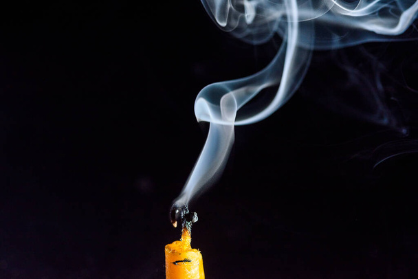 Smoke on a dying candle against a dark background. - Valokuva, kuva