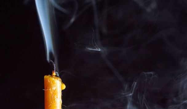 Smoke on a dying candle against a dark background. - Foto, immagini