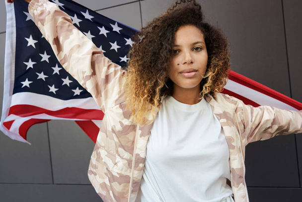 Portrait of young woman with American flag - Photo, Image