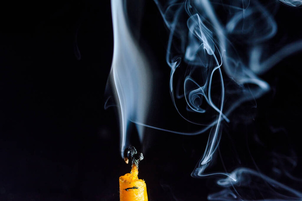 Smoke on a dying candle against a dark background. - Foto, Imagem