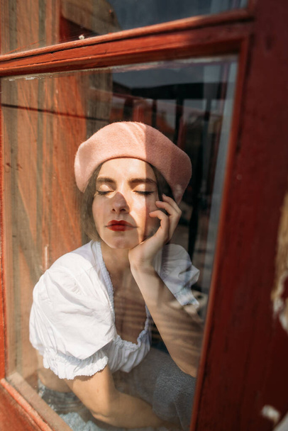 young stylish woman in a beret in an atmospheric interior - Photo, image