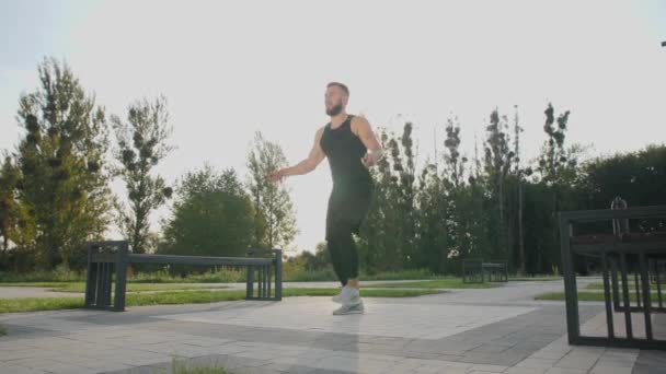 Young man jumping rope outdoors. - Footage, Video